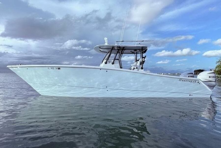 2019 Freeman 34 boat on calm water under cloudy sky.