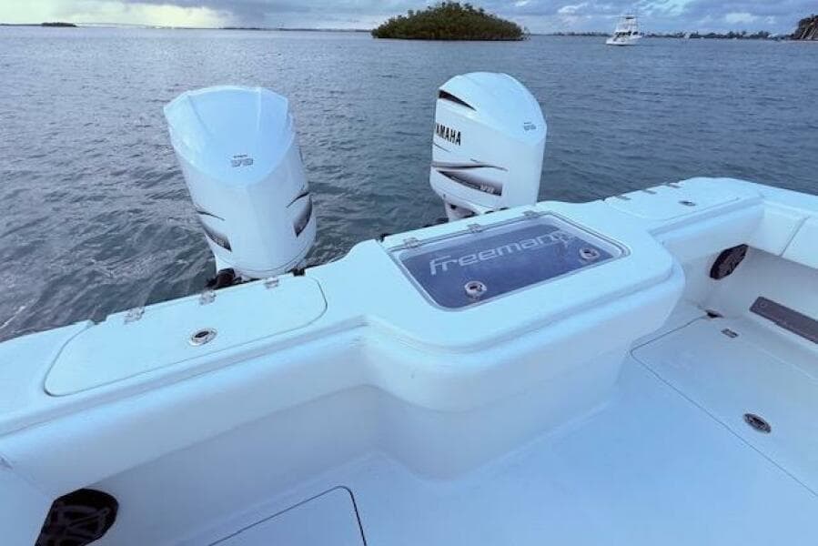 2019 Freeman 34 boat with Yamaha engines on calm water.
