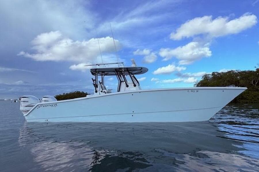 2019 Freeman 34 boat on calm water under a partly cloudy sky.