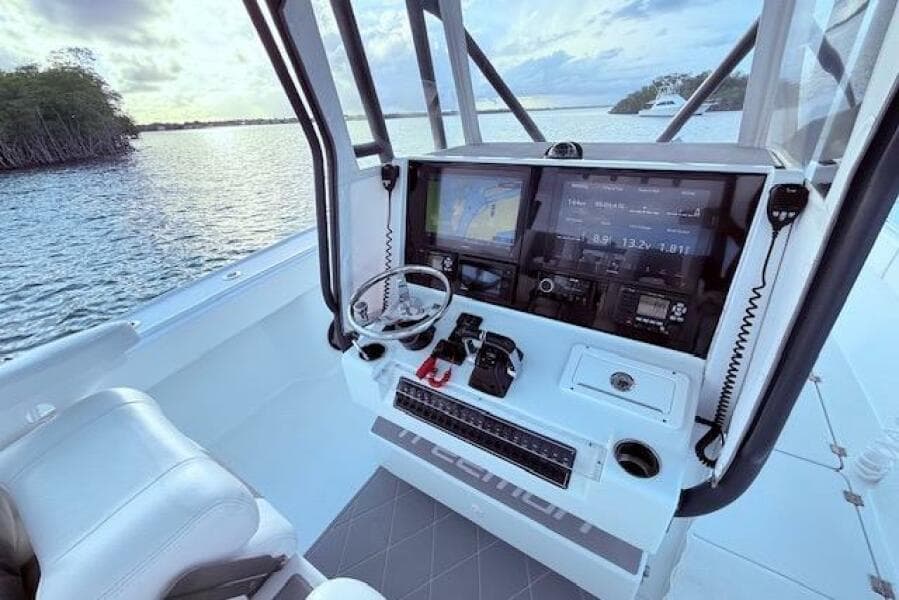 2019 Freeman 34 boat cockpit with advanced navigation system and scenic water view.