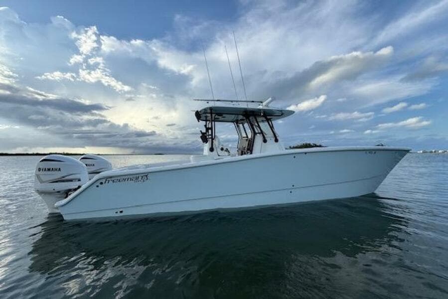 2019 Freeman 34 boat on calm water under a cloudy sky.