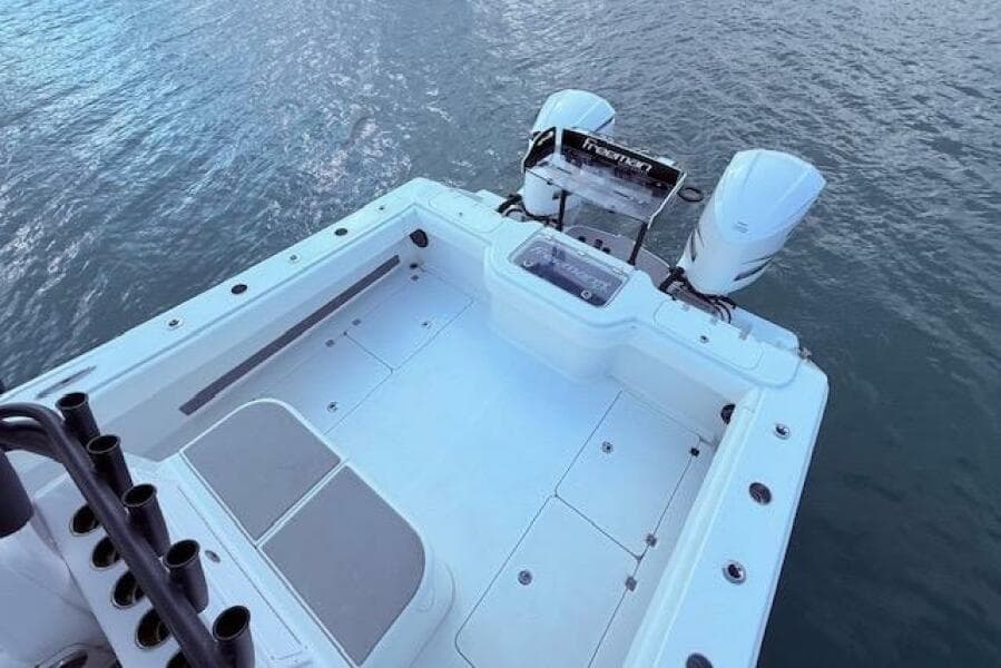 2019 Freeman 34 boat with dual engines on calm water.