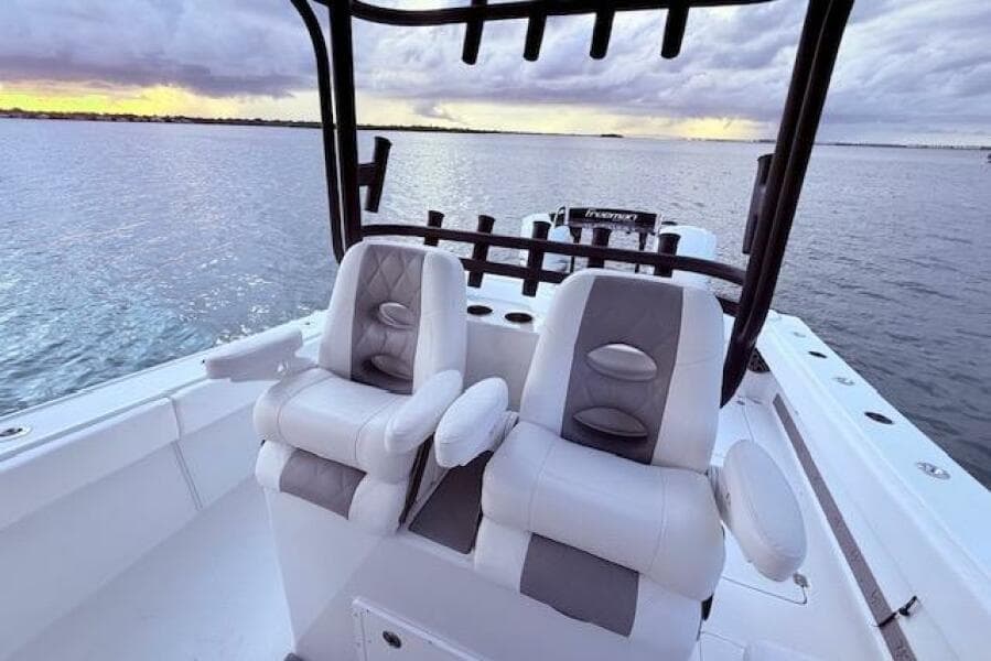 2019 Freeman 34 boat interior with dual seats, overlooking calm waters at sunset.