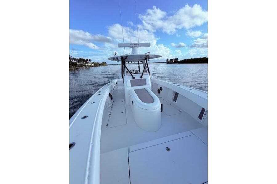 2019 Freeman 34 boat on calm water under a blue sky with clouds.