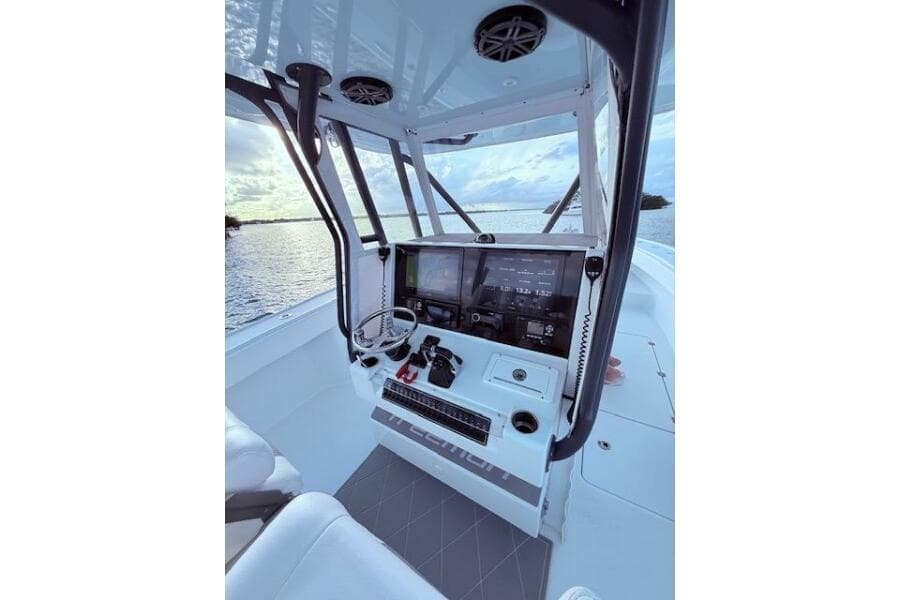 2019 Freeman 34 boat cockpit with modern navigation equipment, overlooking serene water.