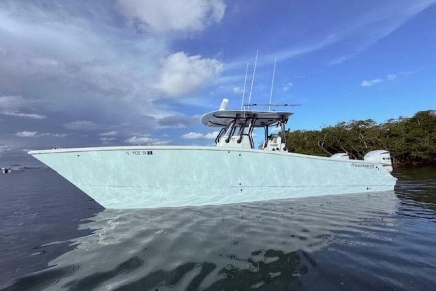 2019 Freeman 34 boat on calm water under a cloudy sky.