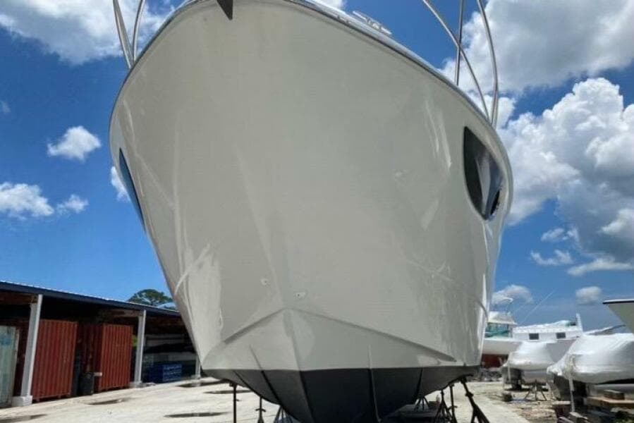 2014 Beneteau Gran Turismo 44 yacht on dry dock under a clear blue sky.
