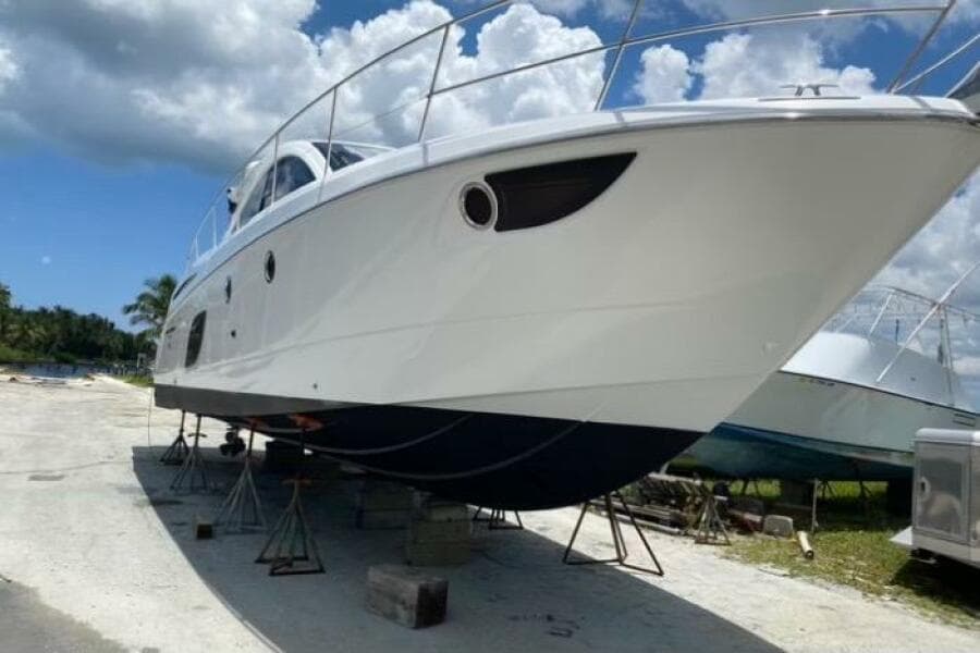 2014 Beneteau Gran Turismo 44 yacht on stands, clear sky background.