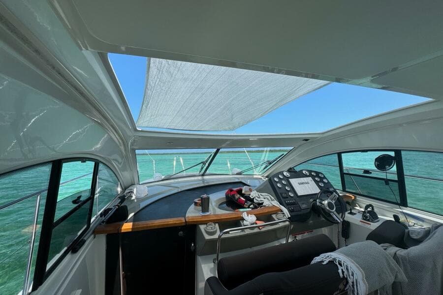 Interior view of 2014 Beneteau Gran Turismo 44 yacht cockpit with ocean backdrop.