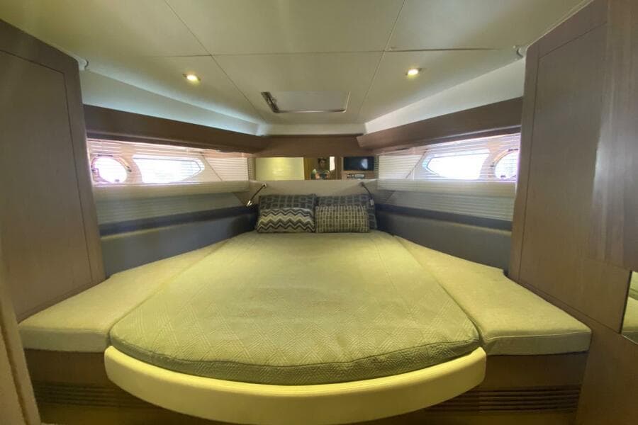 Luxurious cabin interior of 2014 Beneteau Gran Turismo 44 yacht with cozy bedding.