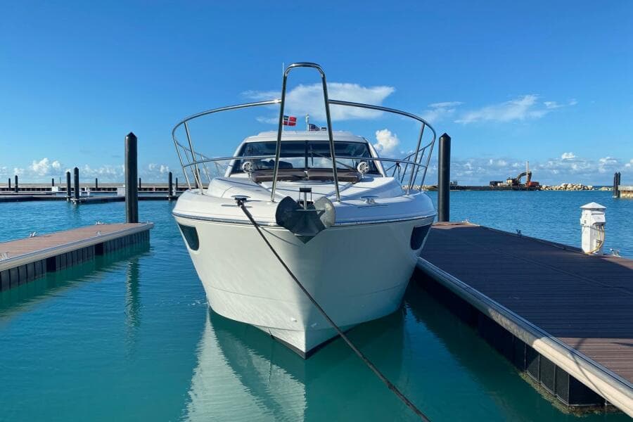 2014 Beneteau Gran Turismo 44 yacht docked in a serene marina setting.