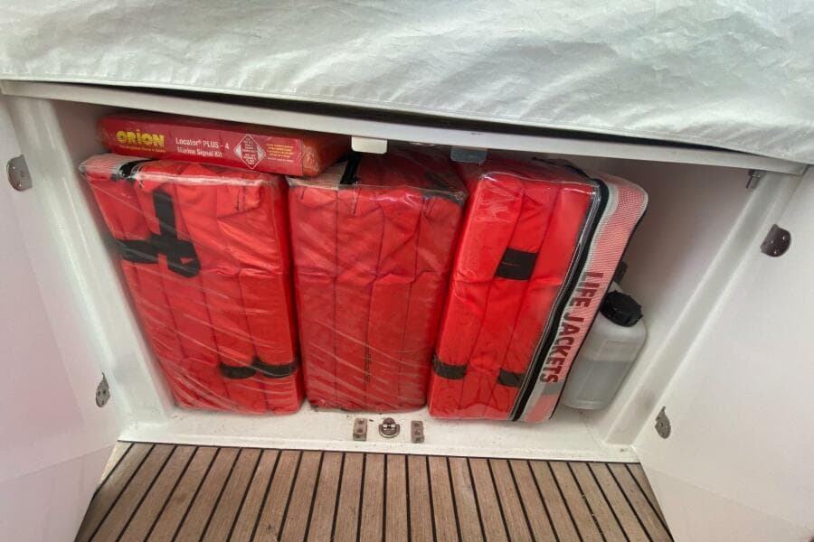 Storage compartment with life jackets and marine signal kit on a 2014 Beneteau Gran Turismo 44.