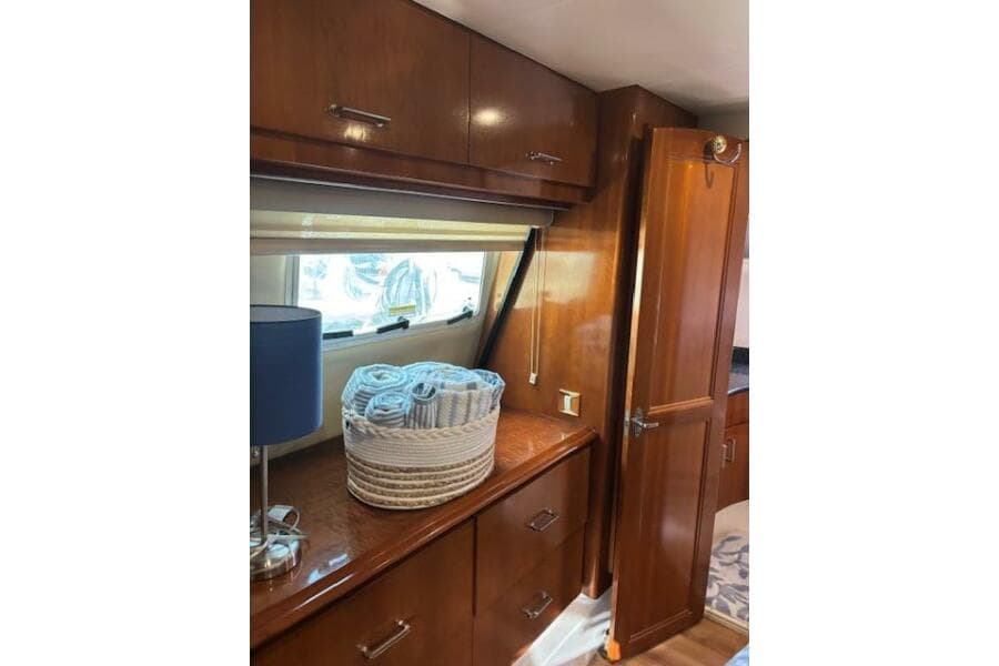 Interior of 2004 Carver 466 Motor Yacht with wooden cabinets and window.