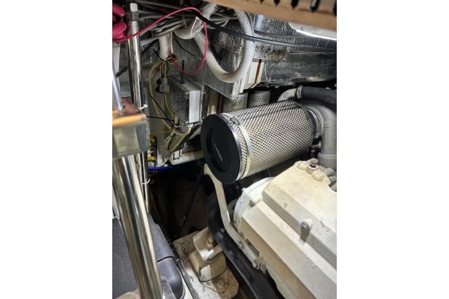 Engine room of 2004 Carver 466 Motor Yacht, showcasing mechanical components and wiring.