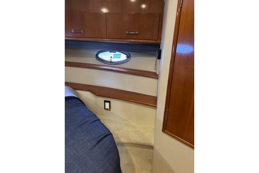 Interior of 2004 Carver 466 Motor Yacht with wood cabinetry and porthole window.