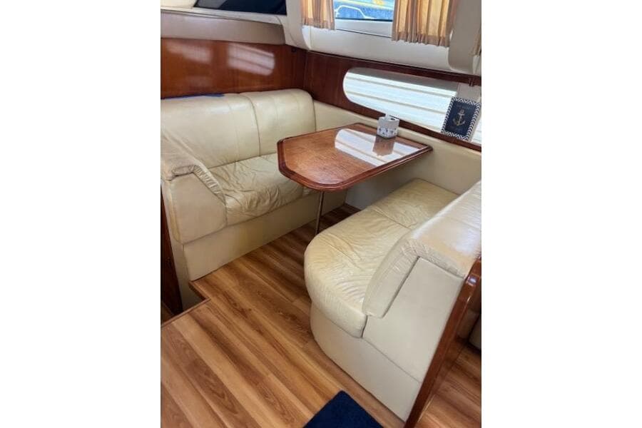 2004 Carver 466 Motor Yacht interior with leather seating and wooden table.