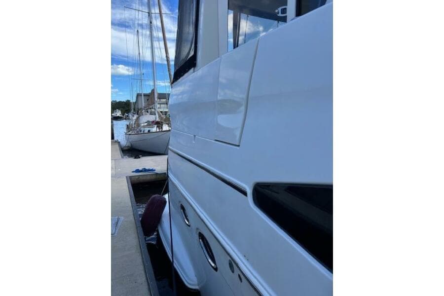 Side view of a 2004 Carver 466 Motor Yacht docked at a marina.