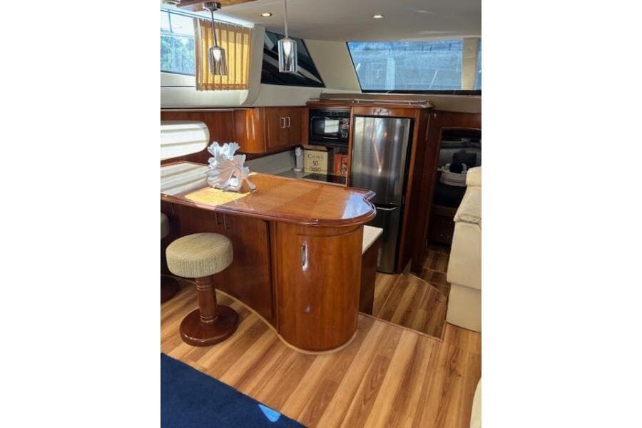 Luxurious interior of 2004 Carver 466 Motor Yacht with elegant wood finishes.