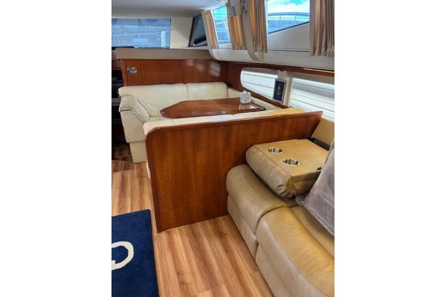 Luxurious interior of 2004 Carver 466 Motor Yacht with leather seating and wood accents.