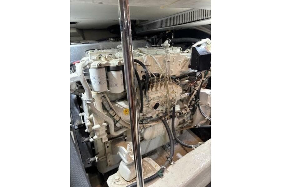 Engine room of 2004 Carver 466 Motor Yacht, showcasing detailed machinery components.