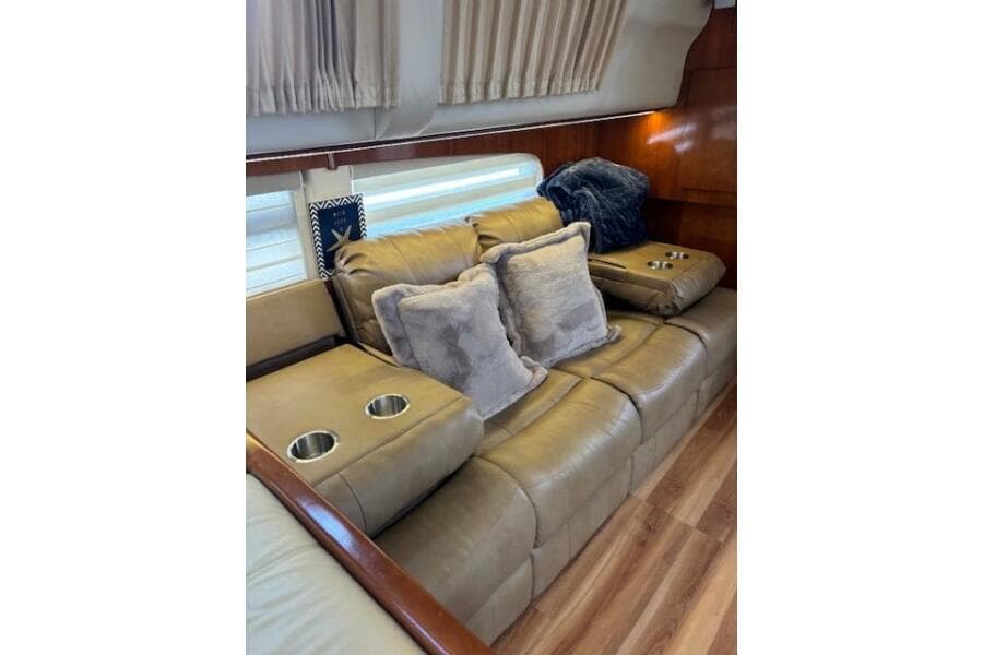 Luxurious interior of 2004 Carver 466 Motor Yacht with plush seating and cushions.