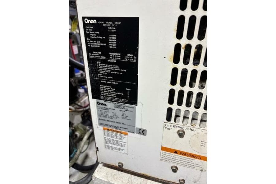 Onan generator panel on 2004 Carver 466 Motor Yacht, showing specifications and warnings.