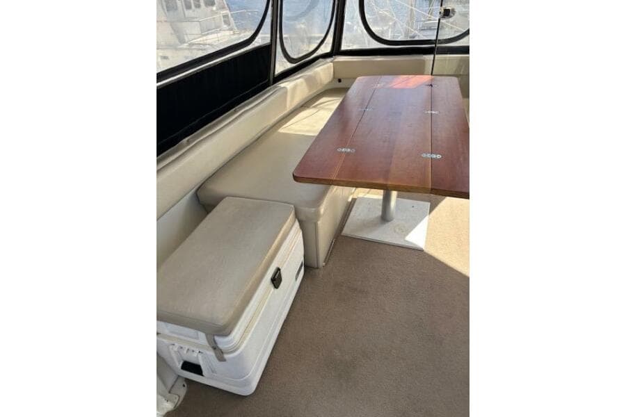 Interior of 2004 Carver 466 Motor Yacht with seating and wooden table.