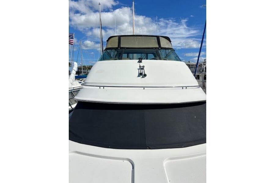 2004 Carver 466 Motor Yacht docked under a clear blue sky.