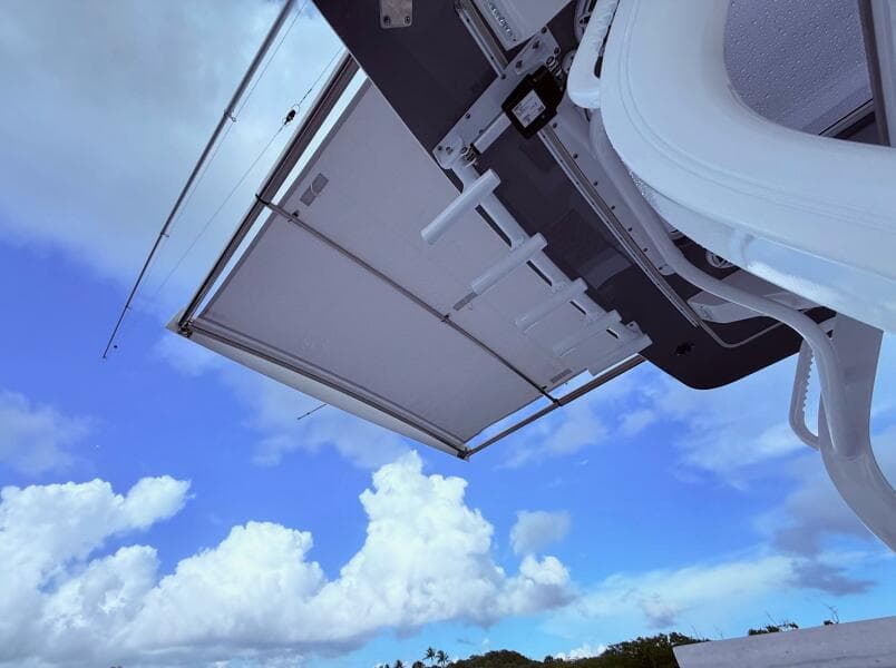 2024 Scout 400 LXF boat canopy against a bright blue sky with clouds.