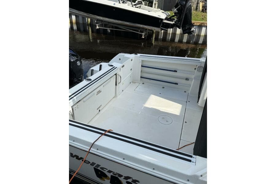 2002 Wellcraft 290 Coastal boat deck, spacious and clean, docked by the water.