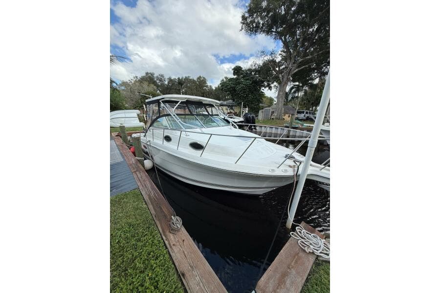 2002 Wellcraft 290 Coastal boat docked, featuring sleek design and spacious cabin.