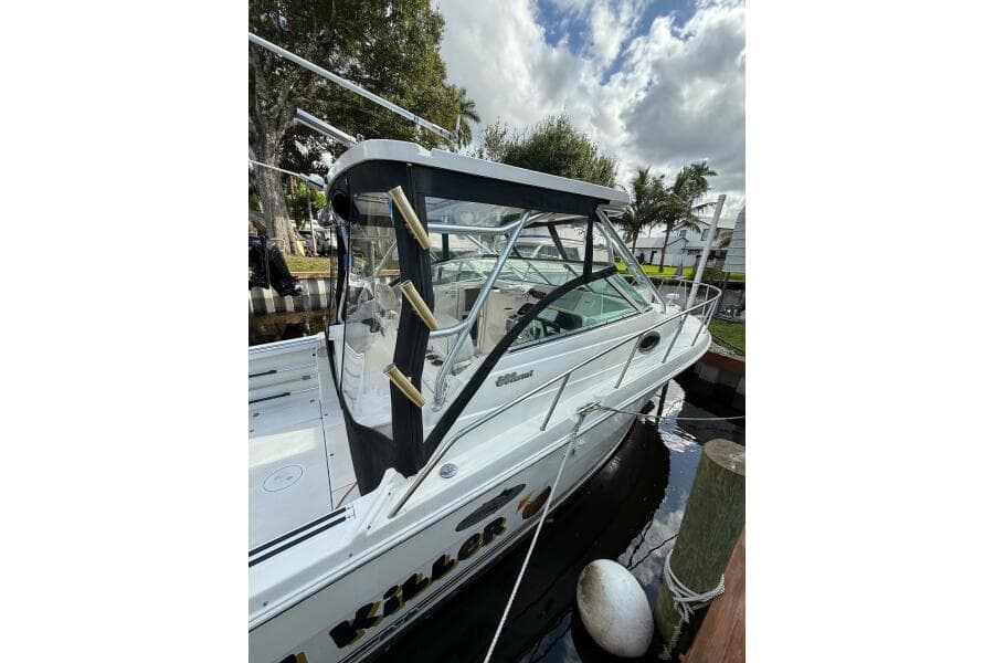 2002 Wellcraft 290 Coastal boat docked, featuring sleek design and sturdy construction.