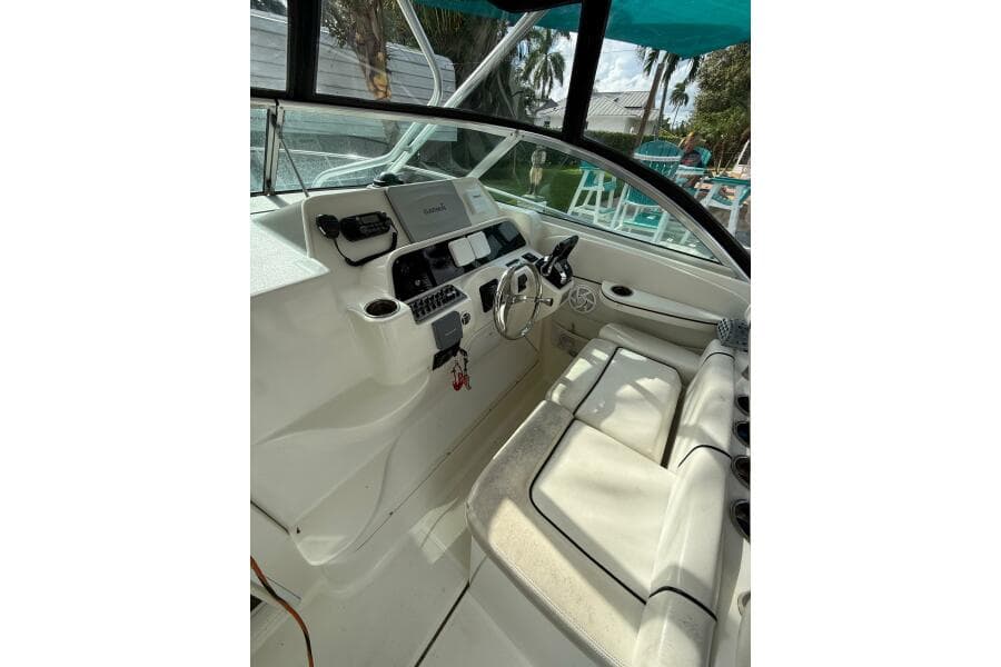 2002 Wellcraft 290 Coastal boat interior with steering wheel and seating area.