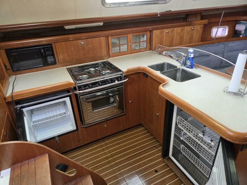 Galley with fridge, freezer, sink, propane cooktop/oven
