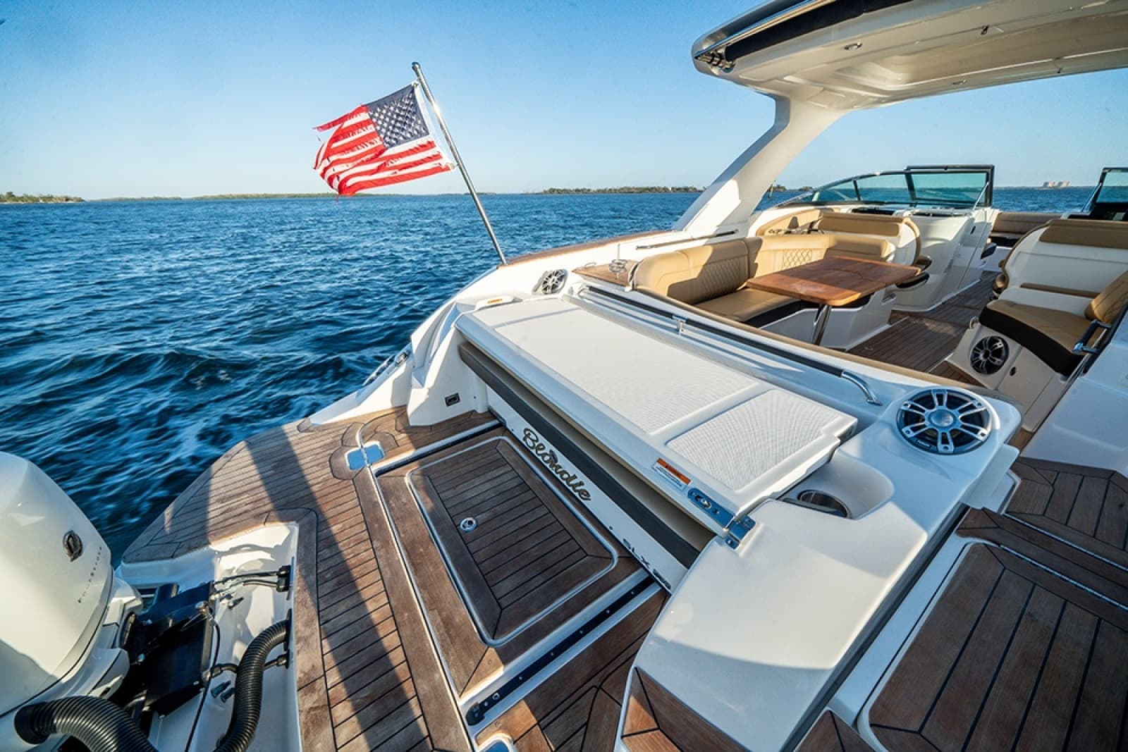 Concealable aft-facing transom lounger (folded)